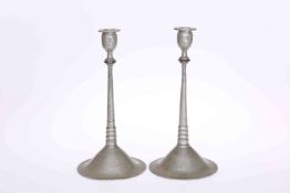 A PAIR OF CONTINENTAL PEWTER CANDLESTICKS, CIRCA 1910, each candle cup with stamped mark,