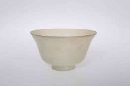 A CHINESE JADE BOWL, with flared rim and set-back circular foot. 6cm high, 10.