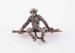 A VICTORIAN PASTE SET BROOCH, modelled as a monkey sitting on a brooch bar,