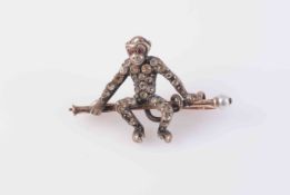 A VICTORIAN PASTE SET BROOCH, modelled as a monkey sitting on a brooch bar,