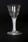 A MID 18TH CENTURY DOUBLE OPAQUE TWIST WINE GLASS, with ogee bowl and plain circular foot. 12.