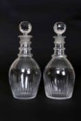 A PAIR OF EARLY 19TH CENTURY DECANTERS, each with facet cut triple ring neck and slice-cut lappets.