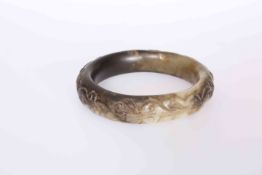 A CHINESE CARVED JADE BANGLE, carved with lizard like creatures. 8.