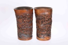 A PAIR OF CHINESE BAMBOO BRUSH POTS, CIRCA 1900, carved with figures on horseback. 28.