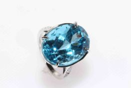 18 carat white gold and oval blue topaz and round diamond shoulder ring,