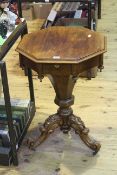 Victorian rosewood octagonal sewing table on carved triform base.