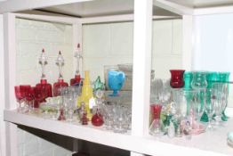 Collection of clear and coloured glassware including cranberry bells