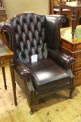 Ox blood buttoned leather wing back armchair