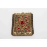 Fancy gilt metal compact with bright red stones