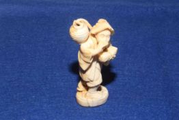 Antique ivory okimono, signed on base,