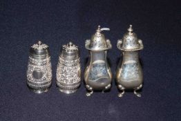 Pair Victorian silver pepperettes with chased bodies and vacant cartouche by Aldwinckle and Slater,