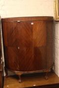 Mahogany demi lune cabinet on ball and claw legs and cane panelled commode armchair (2)