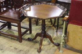 Octagonal mahogany tripod occasional table with carved pierced border,