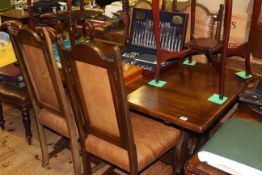 Rectangular oak dining table and four studded arched back dining chairs