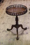 Circular mahogany tripod table with spindled gallery, 46cm diameter.