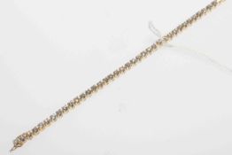 18 carat gold and round brilliant diamond tennis bracelet, diamond total approximately 4.