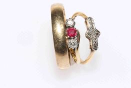 Two 18 carat gold gem set rings and one 9 carat gold wedding band (3)