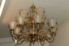 Twelve branch brass chandelier with shades and collection of mainly railway related prints