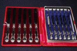 Two sets of boxed silver handled tea knives