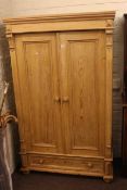 Continental pine wardrobe having two panelled doors above a long drawer