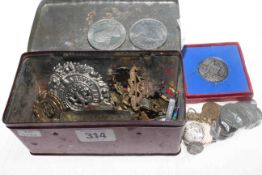 Coins including Victoria crown and tin of mostly cap badges