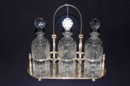 Silver plated three decanter tantalus with swing handle, makers mark RPL,