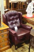 Burgundy buttoned leather wing back armchair
