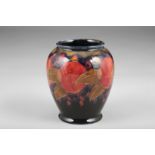 Moorcroft pottery vase, baluster form decorated with pomegranate design, incised to base, 15cm high