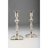 Pair William IV silver candlesticks with knopped stem on shaped stepped square base with foliate