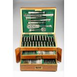 Oak canteen of George V silver cutlery, hinged lid over two fitted drawers, fitted with five piece