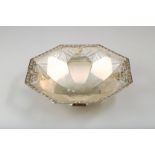 Silver octagonal shaped basket, floral rim with pierced faceted sides raised on an octagonal foot,