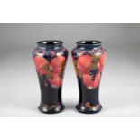 Pair Moorcroft pottery vases, baluster form, pomegranate pattern, signed to base. 27.5cm high (one