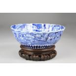 Large 19th/20th Century Japanese blue and white bowl, with lobed rim, floral decoration, raised on a