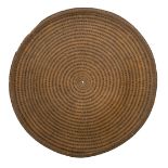 A CIRCULAR CANE SHIELD, LATE 19TH/20TH CENTURY SOUTHEAST ASIAN OR CHINESE