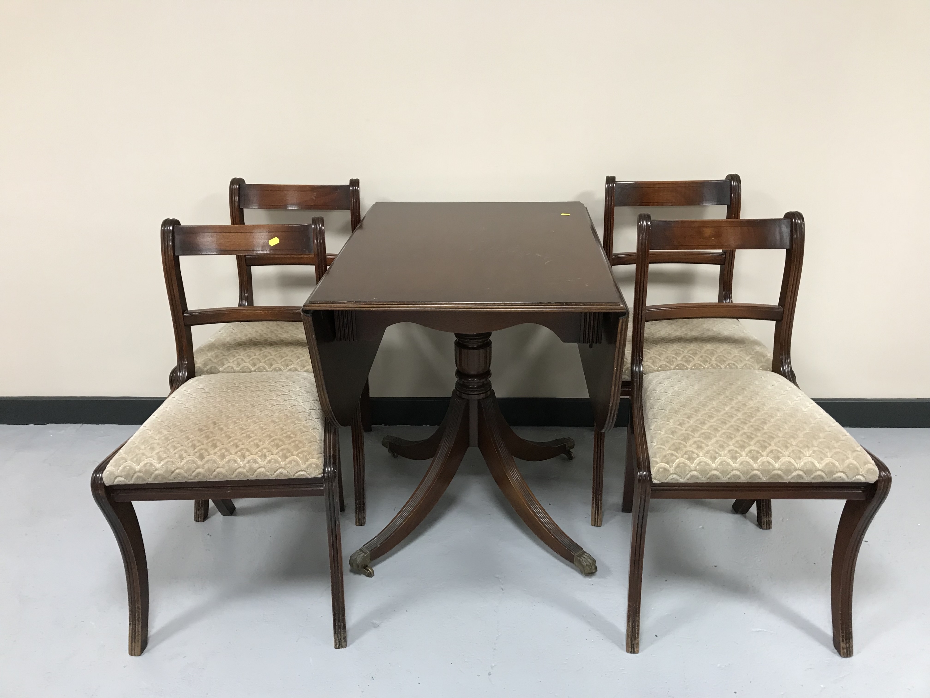 A mahogany drop leaf pedestal table and four chairs