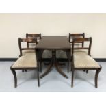 A mahogany drop leaf pedestal table and four chairs