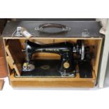 A cased mid twentieth century Singer hand sewing machine