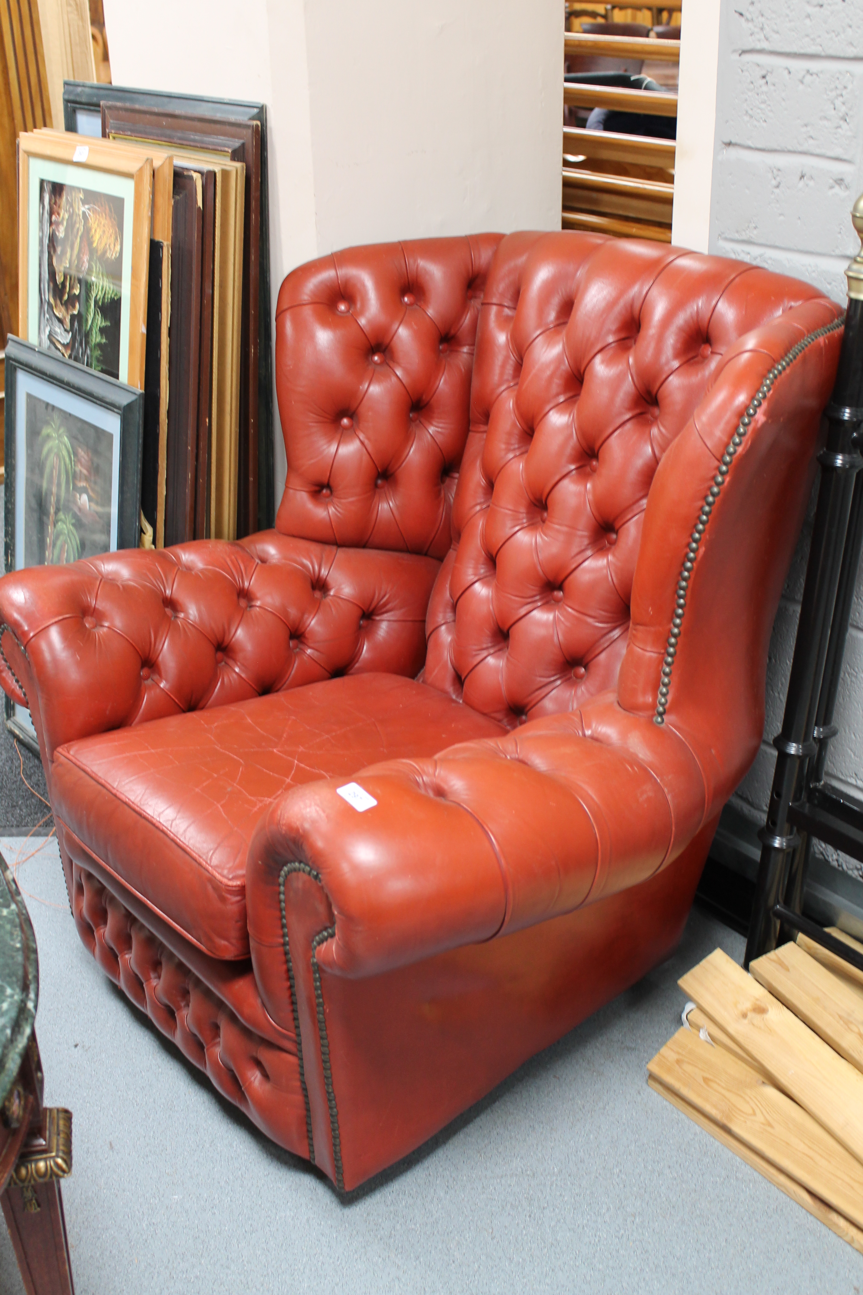 A red button leather Chesterfield armchair