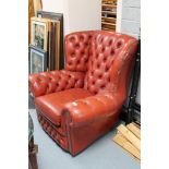 A red button leather Chesterfield armchair