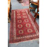 A fringed Afghan Tekke woollen rug on red ground,