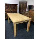 A contemporary dining table in an oak finish