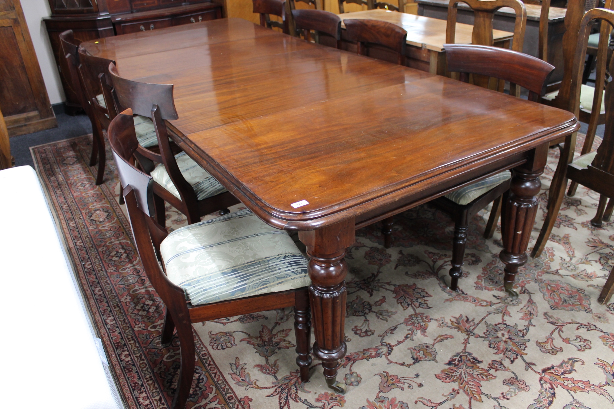 A Victorian mahogany wind-out dining table with three leaves and eight chairs CONDITION - Image 2 of 9