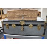 A mid 20th century metal trunk and a vintage picnic basket