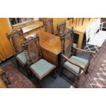 An early twentieth century oak drop leaf barley twist dining table together with a set of five