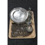 A tray of six circular pewter chargers, a cast metal plaque depicting a nativity scene,