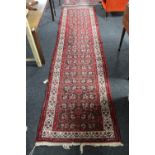 A fringed North-West Persian runner on red ground,