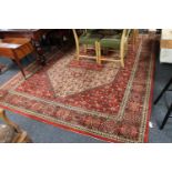 A large machine-made Indian carpet on red ground,