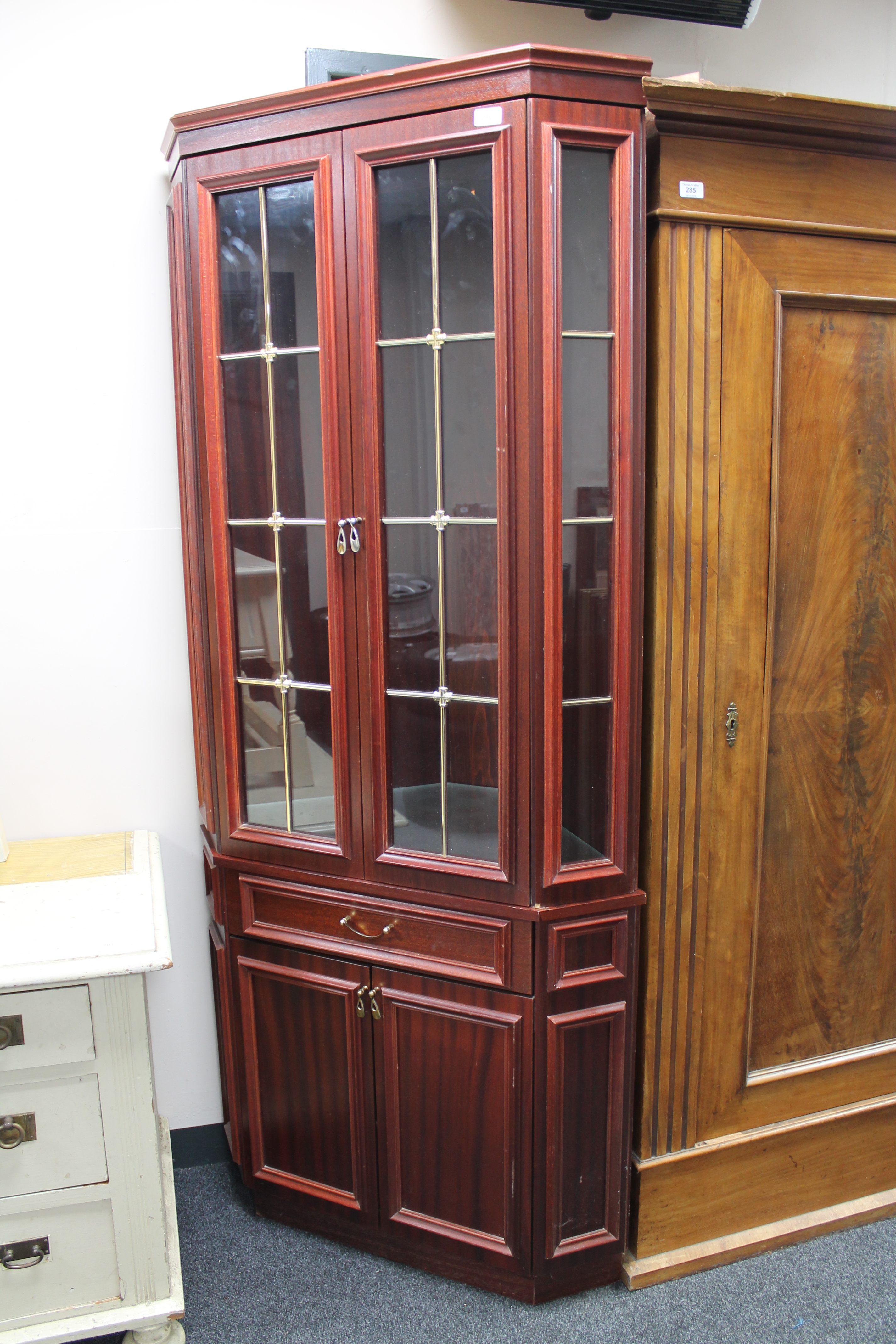 A mahogany glazed door corner cabinet