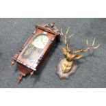 A Polaris 31 day wall clock and a plastic deer's head