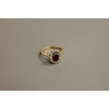 An 18ct gold ruby and diamond cluster ring, size N-O, 4.1g.